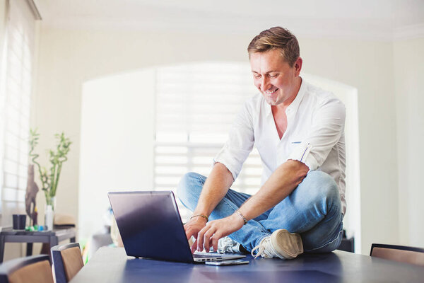 Handsome Caucasian Man Working Home House Sitting Table While Using Stock Photo