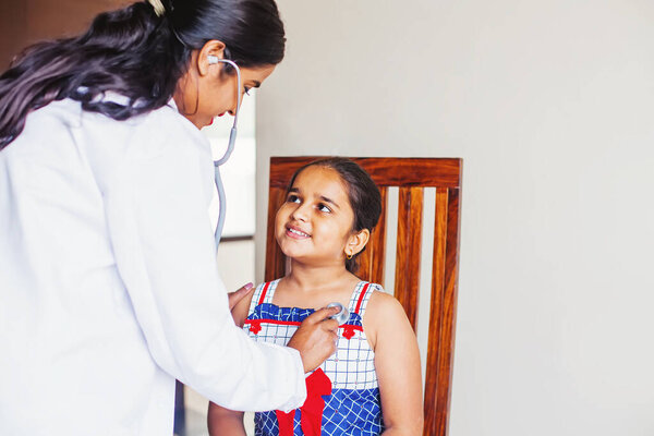 Cute Indian Little Girl Being Examined Paediatric Doctor Stock Photo