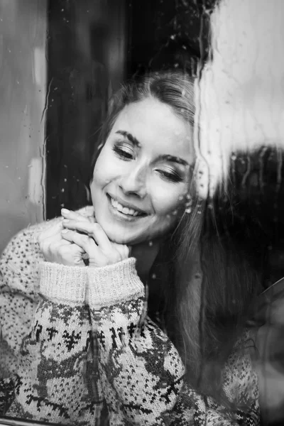 Beautiful young woman  behind the glass — Stock Photo, Image