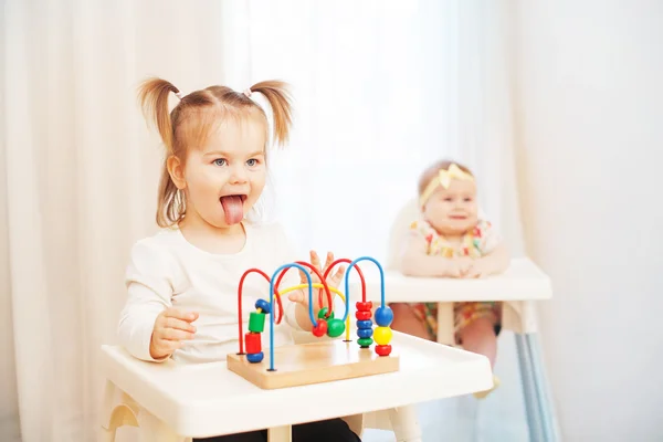 Two little girls in highchairs — Stock Photo, Image