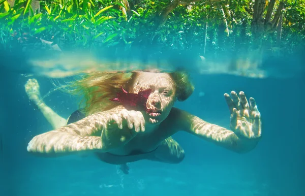 Redheaded girl swimming underwater — Stock Photo, Image