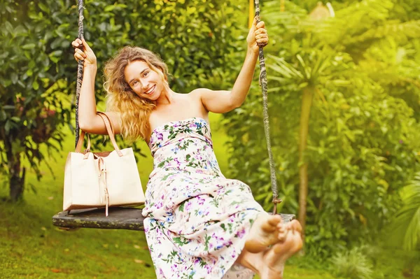 Pretty woman on a swing — Stock Photo, Image