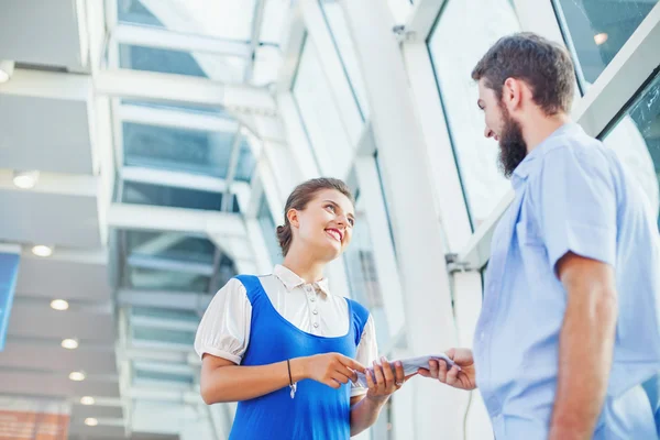 Flight attendant checking documents of  tourist — Stock Photo, Image