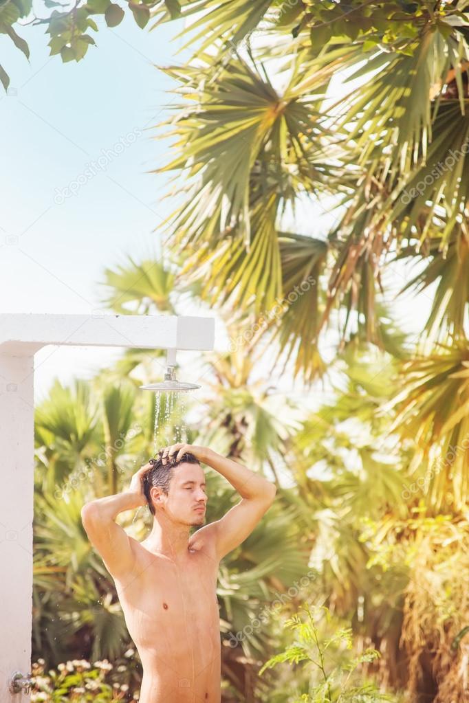 man enjoying washing outdoors