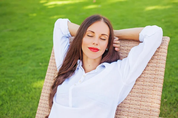 Woman relaxing in a lounger — Stock Photo, Image
