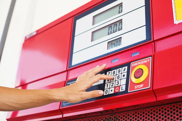 Hand pressing buttons on a fuel machine — Stock Photo, Image