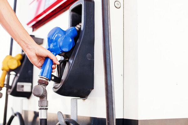 hand refueling a car