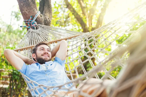 Young man lying in hammock — Stock Photo, Image