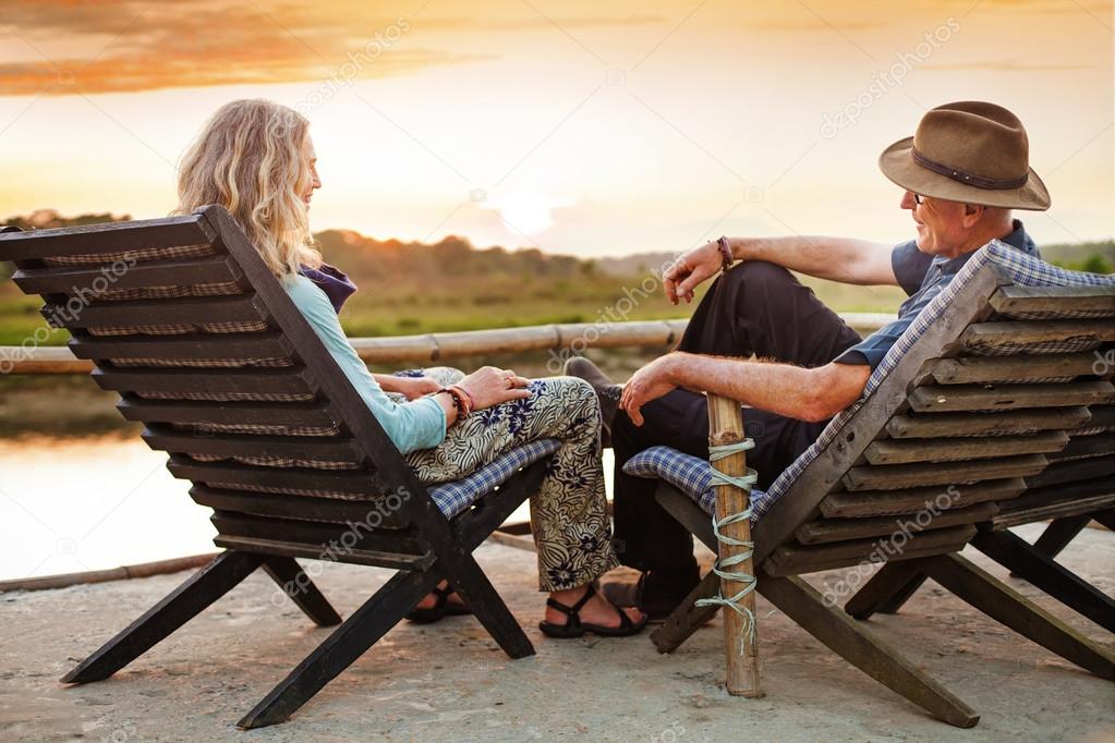 Senior couple sitting on chairs