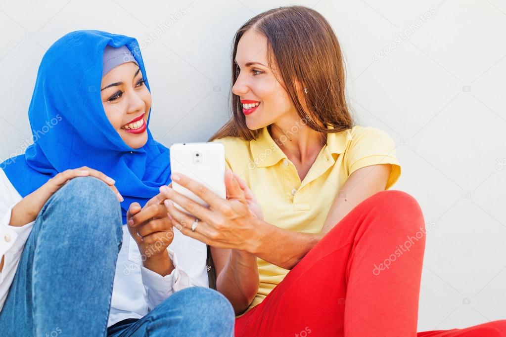 women using phone together