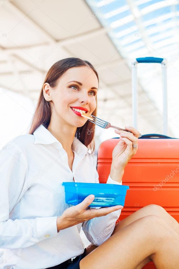 woman eating  while traveling