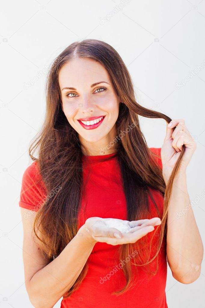 young girl holding a dry shampoo