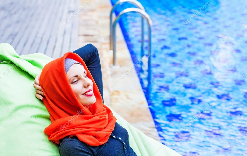 woman relaxing near a swimming pool