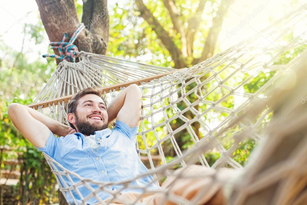 Young man lying in hammock