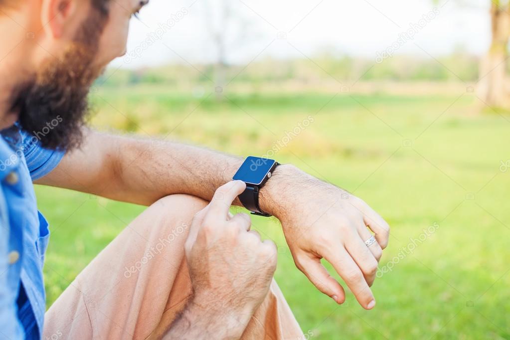 Man clicking on his smart watch.