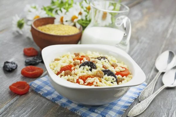 Millet porridge with dried apricots and prunes — Stock Photo, Image