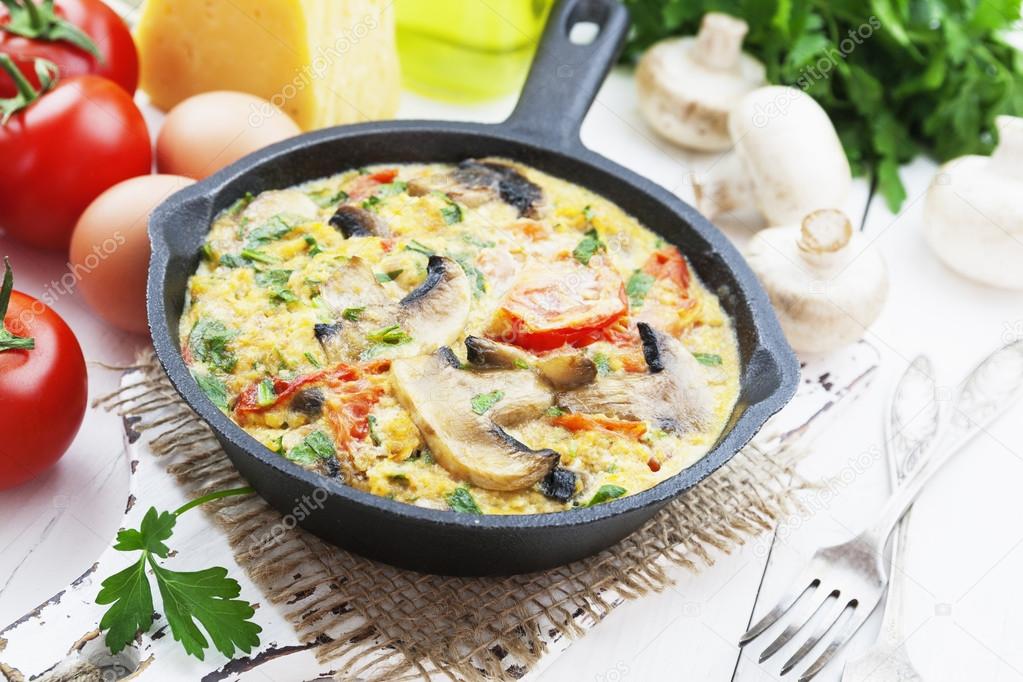 Omelet with mushrooms and tomatoes. Frittata 