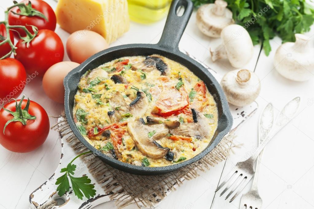 Omelet with mushrooms and tomatoes. Frittata 