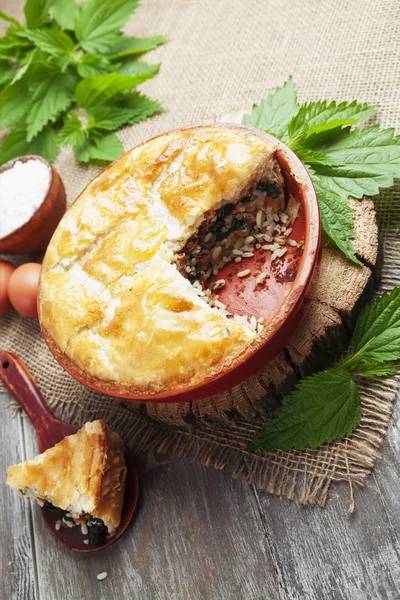 Pie nettles, rice and canned fish — Stock Photo, Image