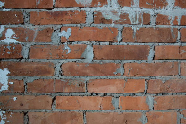 wall of aged bricks and cement texture background image close up
