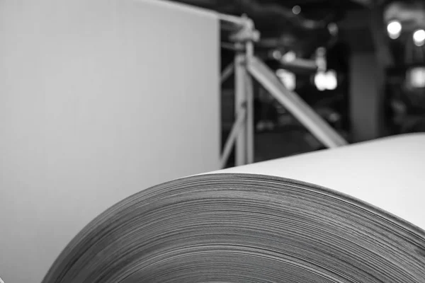 Big Stack of Printing Paper Rolls in Warehouse. The concept of production of paper and paperboard. Industry, copy space. Black and white. Close up view
