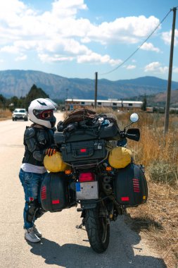 Lady Biker on road, seyahat motosikleti, yaz macerası aktif yaşam tarzı, tatil konsepti Magliano de Marsi, hava yastıkları. Dikey fotoğraf