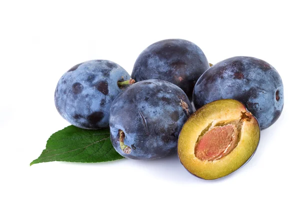 Plums with leaves on white background. Closeup. — Stock Photo, Image