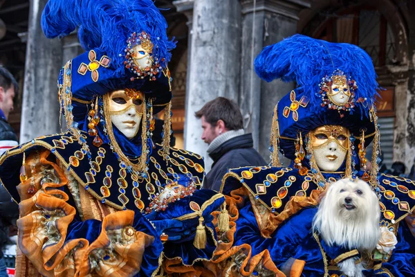 Couple with fantasy Carnival Mask and a dog at Carnival of Venice