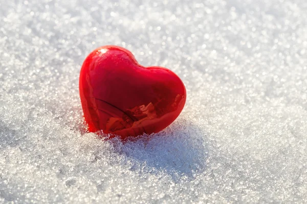 Red heart on ice wet snow, selective focus — Stock Photo, Image