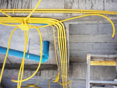 Installing Electrical and Plumbing Conduits Inside a Building During Construction