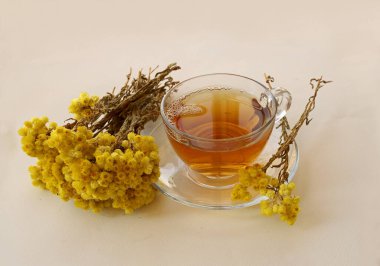 Beyaz zemin üzerinde altın çim (Helichrysum Arenarium) çayı