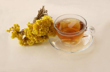 Beyaz zemin üzerinde altın çim (Helichrysum Arenarium) çayı