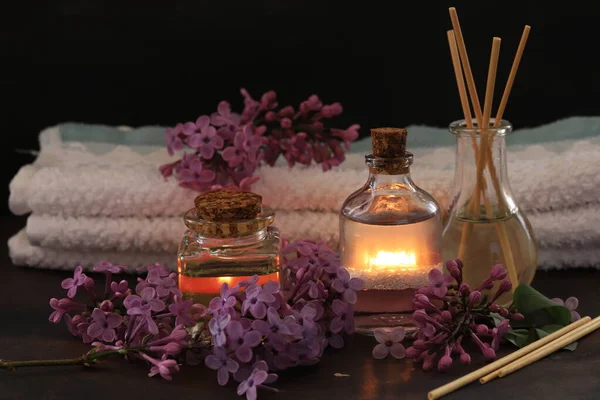 Lilac flowers, lilac oil in bottle, spa