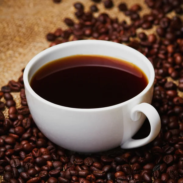 Porcelain mug on grains — Stock Photo, Image