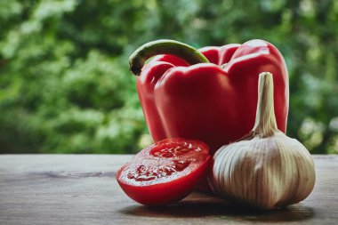 Pepper, half of tomato and garlic head