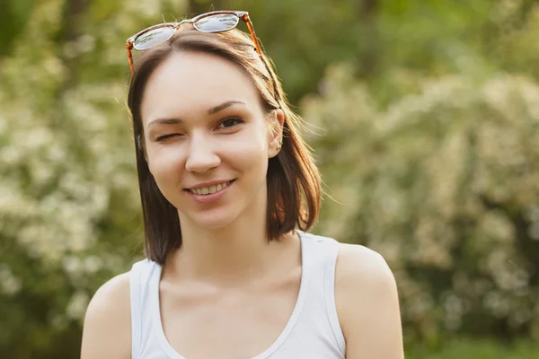 Portrait of young smilling winking girl — Stock Photo, Image