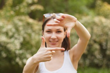 Pretty girl making frame with hands