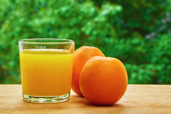 Oranges and glass on the table — 图库照片