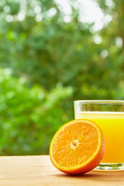 Orange and glass on the table — ストック写真