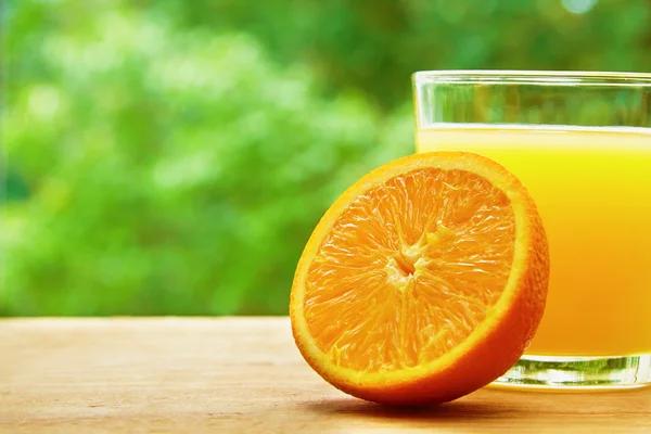 Orange and glass on the table — ストック写真