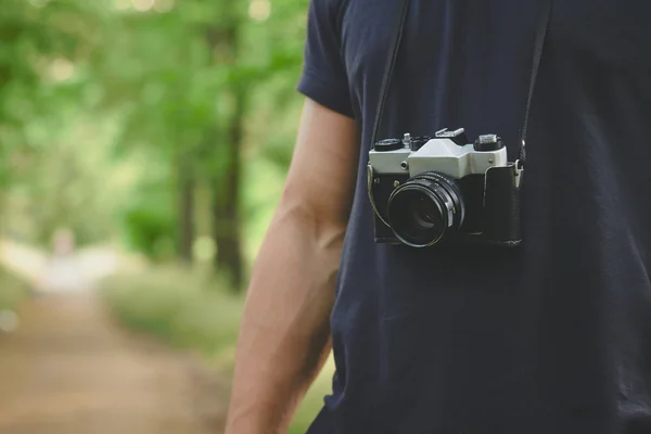 Retro camera on mans chest — Stock Photo, Image