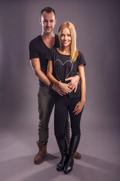 Man and woman posing in studio — Stock Photo, Image