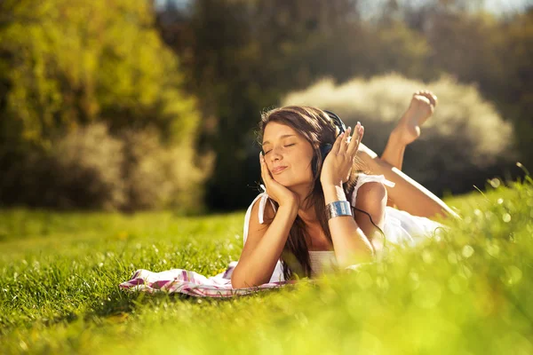 Woman with headphones outdoors — Stock Photo, Image