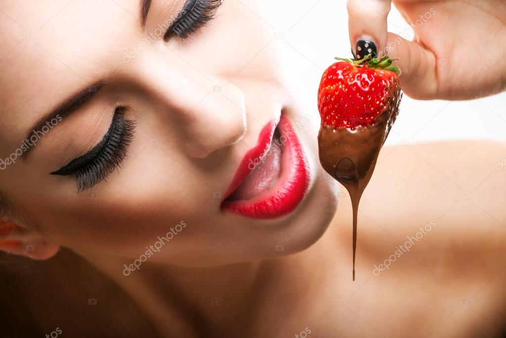 Woman eating chocolate strawberries