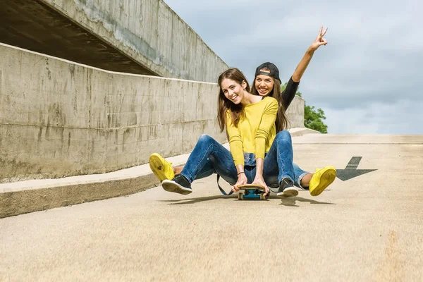 Girls rolling down the slope — Stock Photo, Image