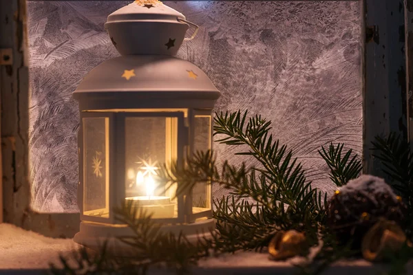 Candles glow in steamy window — Stock Photo, Image