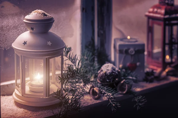 Candles glow in steamy window — Stock Photo, Image