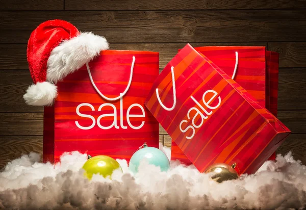 Sale bags with Santa hat — Stock Photo, Image