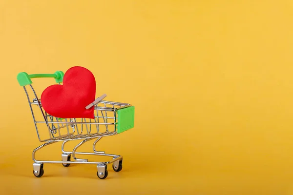 Gran corazón rojo con pin en mini carrito de comestibles — Foto de Stock