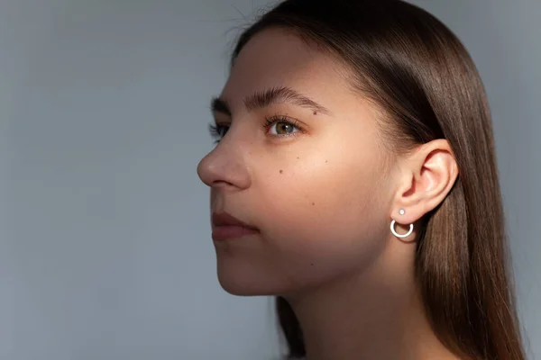 Beautiful jewelry model in modern silver round minimal earrings
